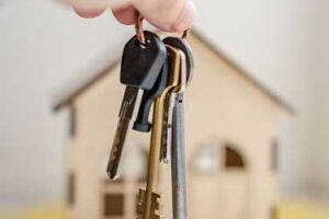 image of hand holding house keys