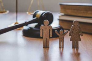 Family cutout with gavel on a desk
